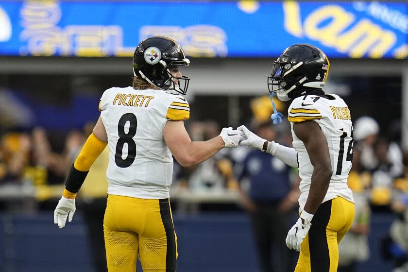 Steelers quarterback Kenny Pickett (left) congratulates George Pickens after a reception against the Rams.