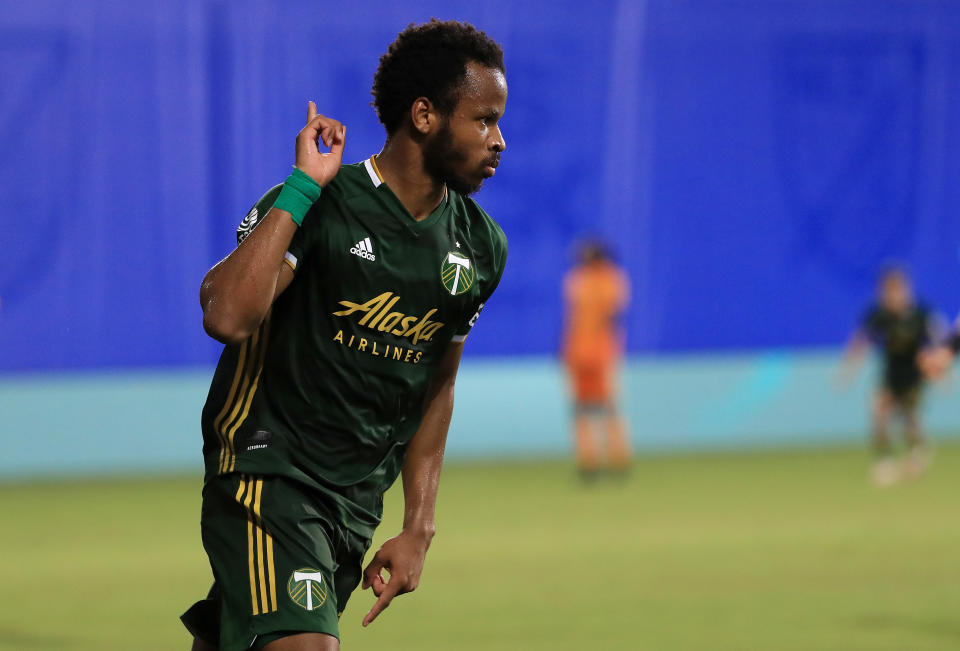 Jeremy Ebobisse celebrates scoring a goal with a raised hand. 