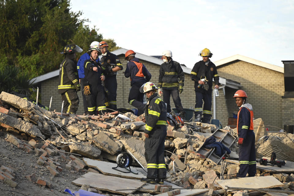 Emergency workers on the scene of a collapsed building in George, South Africa, Tuesday, May 7, 2024. Five workers have been killed with 49 still trapped after the building under construction collapsed Monday. (AP Photo)