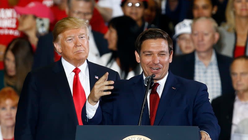 In this Nov. 3, 2018, file photo, President Donald Trump stands behind gubernatorial candidate Ron DeSantis at a rally in Pensacola, Fla.