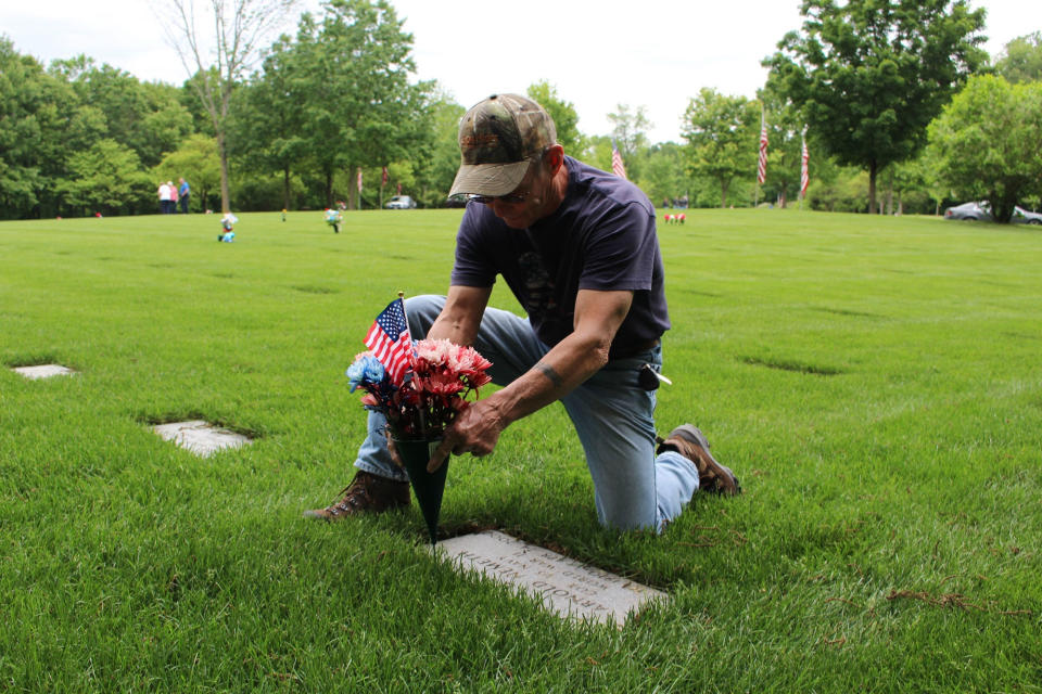 <p>Vietnam-era Marine veteran Jim Segletes of Easton, Pa., places flowers on the grave of his father-in-law, a World War II veteran who died in 2000, at Indiantown Gap National Cemetery in Annville, Pa. on May 27, 2017. (Photo:Michael Rubinkam/AP) </p>