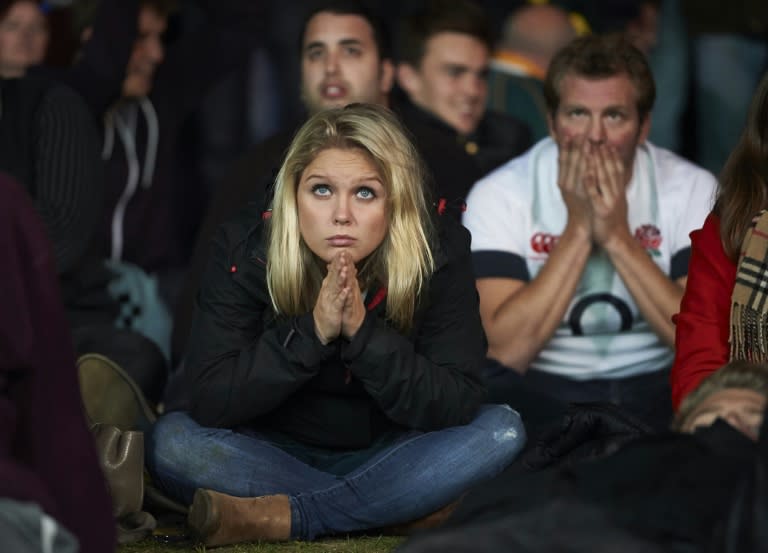 Rugby fans react after watching the Pool A match of the 2015 Rugby World Cup between England and Australia at Twickenham stadium