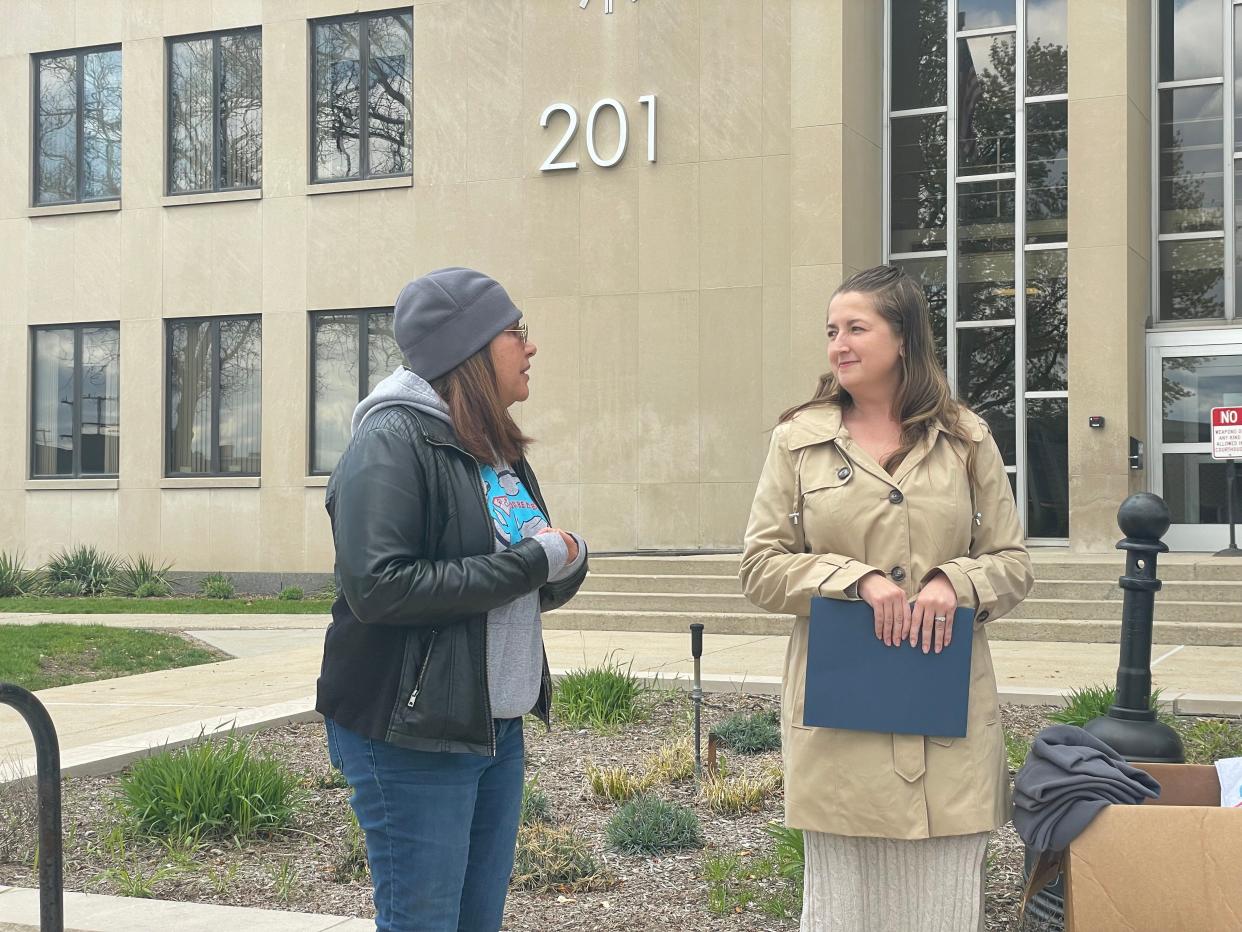 Mara McCalmon, left, and Coutney Carl, right, speaking to a crowd gathered at the St. Clair County Courthouse on April 26, 2023. The people were together to recognize Crime Victim's Rights Week.