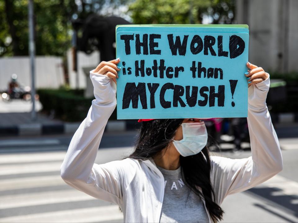 Environmental activists hold a sign during an Earth Day rally in Bangkok (Getty Images)