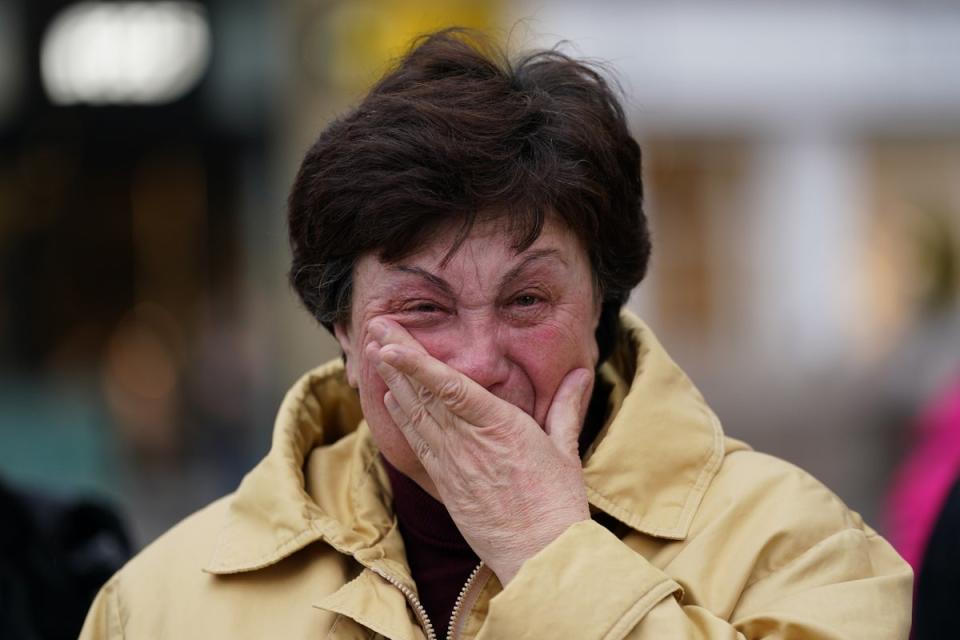 A woman weeps as members of northeast Ukrainian community groups gather at Grey’s Monument to mark the first anniversary of the Russian invasion of Ukraine in Newcastle upon Tyne, United Kingdom (Getty Images)