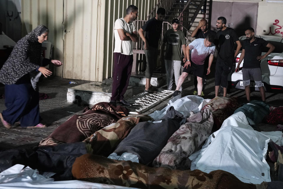 Palestinians mourn their relatives killed in an Israeli bombardment of UNRWA school at Nusseirat refugee camp, in front of the morgue of al-Aqsa Martyrs hospital in Deir al-Balah, central Gaza Strip, early Thursday, June 6, 2024. (AP Photo/Abdel Kareem Hana)