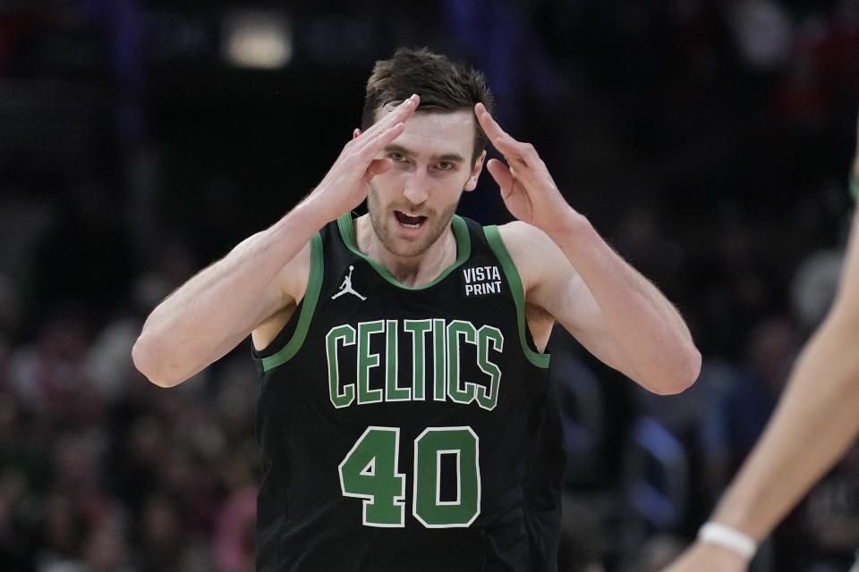 Boston Celtics' Luke Kornet celebrates after his rebound dunk during the second half of an NBA basketball game against the Chicago Bulls, Thursday, Feb. 22, 2024, in Chicago. (AP Photo/Charles Rex Arbogast)