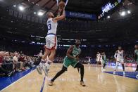 New York Knicks' Evan Fournier (13) shoots over Boston Celtics' Jaylen Brown (7) during the first half of an NBA basketball game Wednesday, Oct. 20, 2021, in New York. (AP Photo/Frank Franklin II)