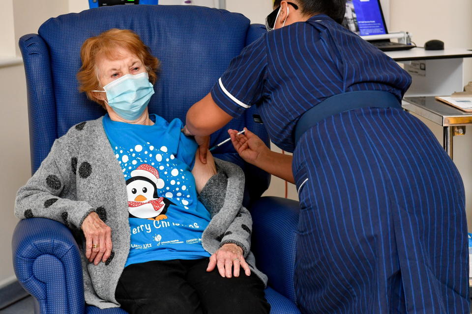 Margaret Keenan, 90, is the first patient in Britain to receive the Pfizer/BioNtech COVID-19 vaccine at University Hospital, administered by nurse May Parsons, on Dec. 8, 2020.  (Photo: Jacob King/Pool via REUTERS TPX IMAGES OF THE DAY)