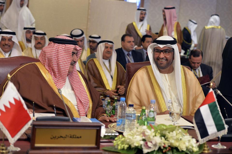 Bahrain's Minister of Foreign Affairs Shaik Khalid bin Ahmed bin Mohammed Al Khalifa, left, talks with his counterpart from the United Arab Emirates, Sheik Abdullah bin Zayed Al Nahyan during an Arab Foreign Ministers session in Kuwait City on Sunday, March 23, 2014. The Arab ministers held a preparatory meeting on Sunday prior to the 25th Arab Summit Tuesday in Kuwait City. (AP Photo/Nasser Waggi)