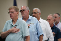 Uvalde Mayor Don McLaughlin, Jr., second from left, stands with fellow council members for the pledge during a city council meeting, Tuesday, July 12, 2022, in Uvalde, Texas. (AP Photo/Eric Gay)
