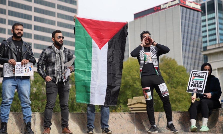 Some of the demonstrators at an "All Out for Gaza" rally Saturday outside the Ohio Statehouse in Columbus hold a Palestinian flag, signs and shout in unison to chants along with the several hundred other participants. The rally then turned into a march that headed north along High Street through Downtown into the Short North and headed toward the Ohio State campus.
