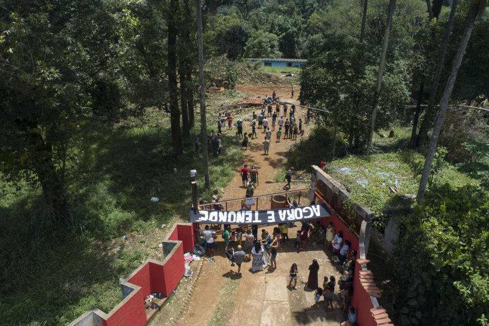 Guarani Mbya protesters occupy land being cleared by real estate developer Tenda which plans to build apartment buildings, next to their indigenous community's land in Sao Paulo, Brazil, Thursday, Jan. 30, 2020. The tension between a builder with projects in nine Brazilian states and a 40-family indigenous community is a microcosm of what’s playing out elsewhere in the country. (AP Photo/Andre Penner)