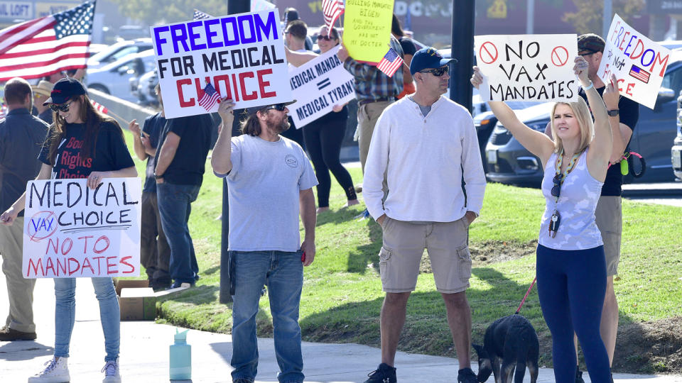 Employees and supporters of the Naval Surface Warfare Center in California hold signs reading “No vax mandates” and “Freedom for medical choice.”