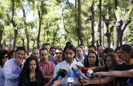 A Gowex workers spokesman reads a statement to the media in front of other Gowex workers outside their offices in central Madrid in this July 10, 2014 file photo. REUTERS/Javier Barbancho/Files