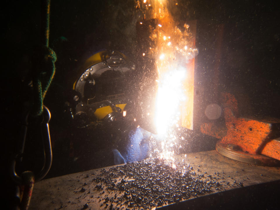 A welder working underwater