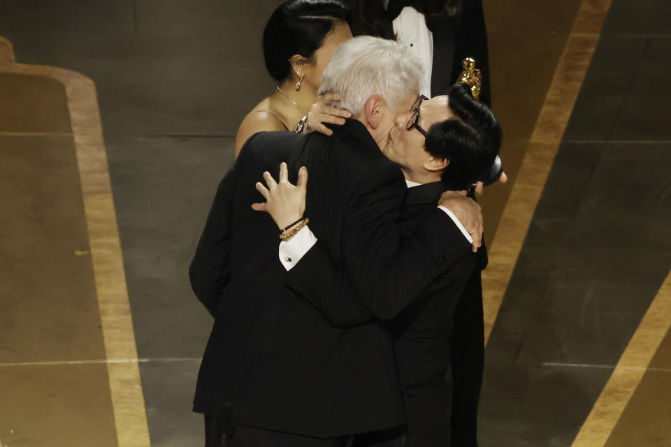 Ke Huy Quan kisses Harrison Ford's cheek on stage