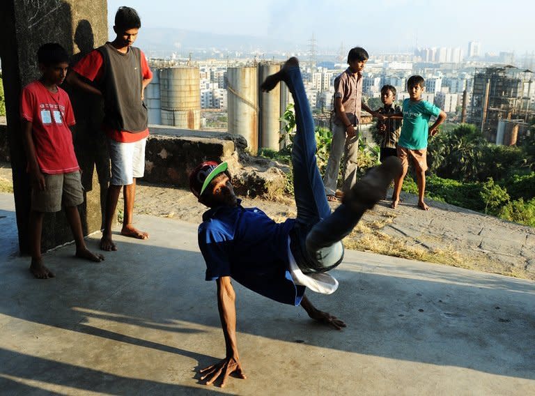 SlumGods members take part in a dance practice at the Sion fort in Mumbai on November 30, 2012. They have inspired hundreds of urban Indian youngsters to try their hands at graffiti, rapping or especially b-boying, a cheap and funky combination of exercise and self-expression