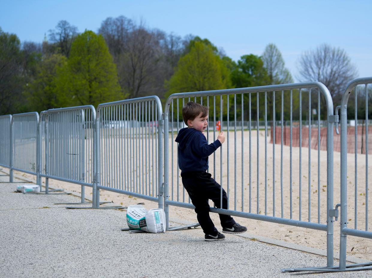 Lucas Lois, 4, who was with his father, Ryan Lois of Racine, watches the seagulls through the barricades at McKinley Beach on Tuesday, May 24, 2022, in Milwaukee.