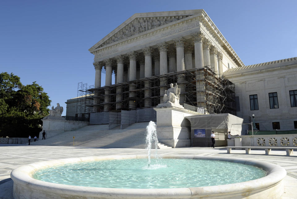 FILE - This Oct. 15, 2013, file photo shows the Supreme Court in Washington the day the court's justices said they would be reviewing whether or not the Environmental Protection Agency overstepped its authority in developing rules aimed at cutting emissions of six heat-trapping gases from factories and power plants. Monday, Feb. 24, 2014, the Court will hear arguments on the unanimous federal appeals court ruling that upheld the government's unprecedented regulations aimed at reducing the gases blamed for global warming. (AP Photo/Susan Walsh, File)