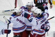 New York Rangers' Mika Zibanejad, rights celebrates his goal with teammates during the third period of the NHL hockey game against the New Jersey Devils in Newark, N.J., Sunday, April 18, 2021. (AP Photo/Seth Wenig)
