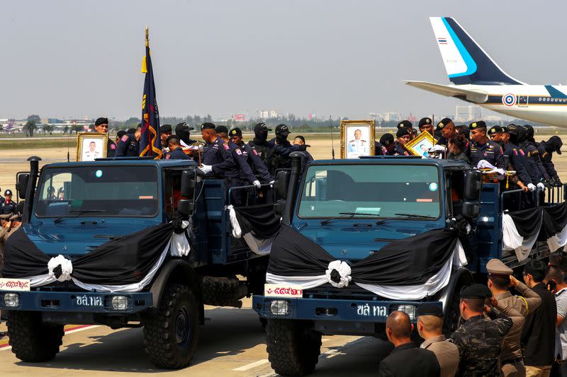 FILE PHOTO: Family members and Police officers ride with coffins containing bodies of SWAT members Trakool Tha-arsa and Petcharat Kamjadpai, who were killed in a mass shooting at the Terminal 21 shopping mall, at a military airport in Bangkok