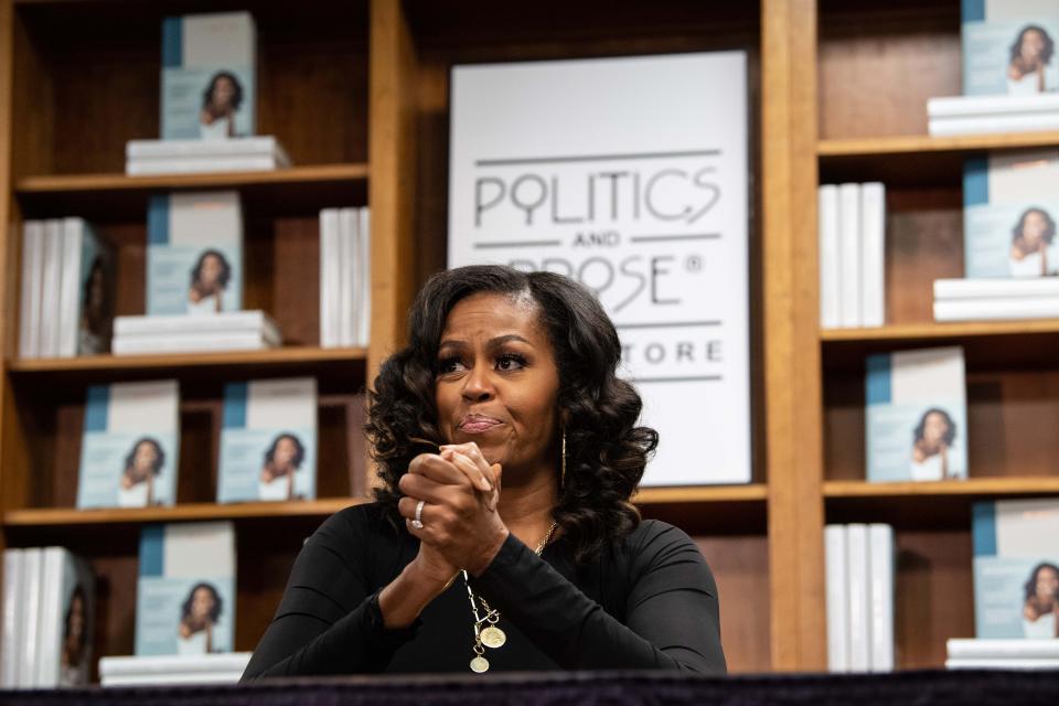 TOPSHOT - Former US first lady Michelle Obama meets with fans during a book signing on the first anniversary of the launch of her memoir 