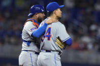 New York Mets catcher Omar Narvaez, left, talks with starting pitcher Kodai Senga during the fourth inning of the team's baseball game against the Miami Marlins, Wednesday, Sept. 20, 2023, in Miami. (AP Photo/Lynne Sladky)