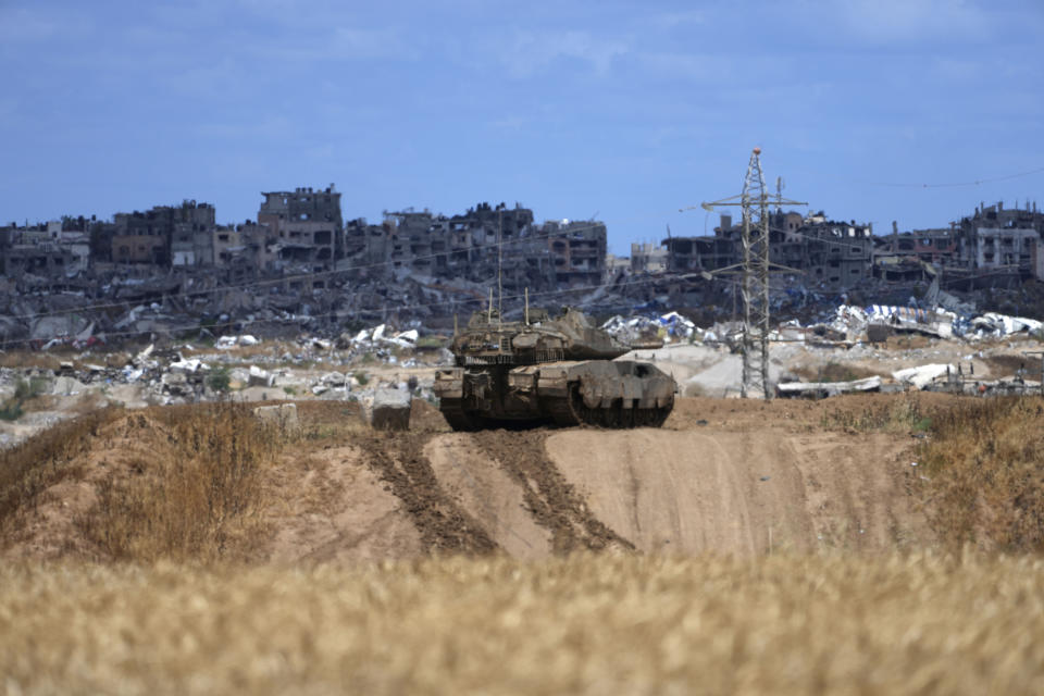 An Israeli tank overlooks the Gaza Strip, as seen from southern Israel, Monday, May 6, 2024. (AP Photo/Tsafrir Abayov)