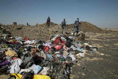 FILE PHOTO: Ethiopian police officers walk past the debris of the Ethiopian Airlines Flight ET 302 plane crash, near the town of Bishoftu, near Addis Ababa, Ethiopia March 12, 2019. REUTERS/Baz Ratner