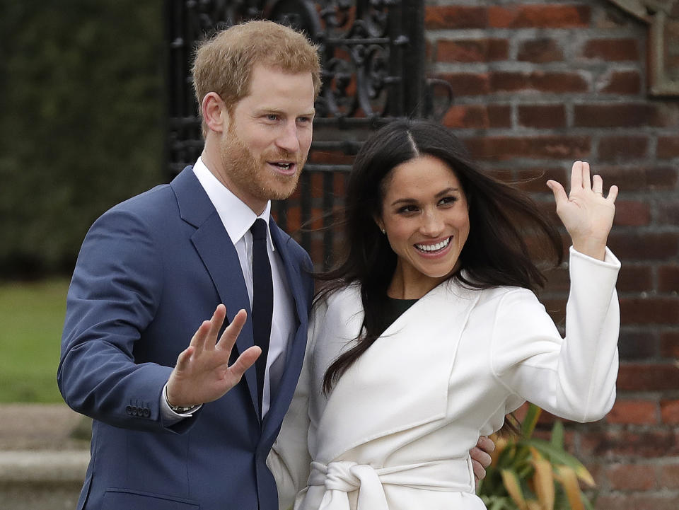 FILE - In this Monday, Nov. 27, 2017 file photo, Britain's Prince Harry and his fiancee Meghan Markle pose for photographers during a photocall in the grounds of Kensington Palace in London. Princess Diana’s little boy, the devil-may-care red-haired prince with the charming smile is about to become a father. The arrival of the first child for Prince Harry and his wife Meghan will complete the transformation of Harry from troubled teen to family man, from source of concern to source of national pride. (AP Photo/Matt Dunham, File)