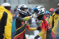 Ann-Christin Strack, left, and Stephanie Schneider, celebrate after winning the women's bobsled World Cup race in Winterberg, Germany, Saturday, Dec. 15, 2018. (Christophe Gateau/dpa via AP)