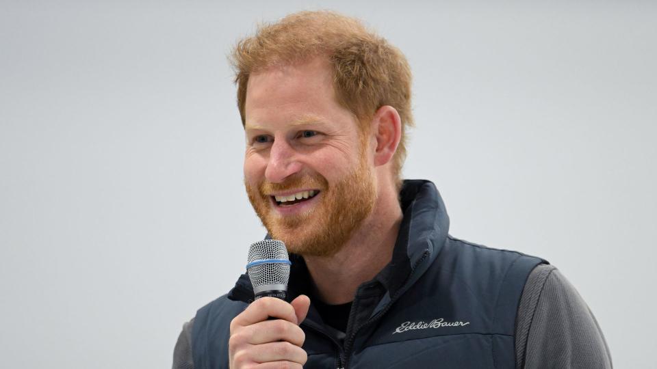 Prince Harry holding a microphone during his speech