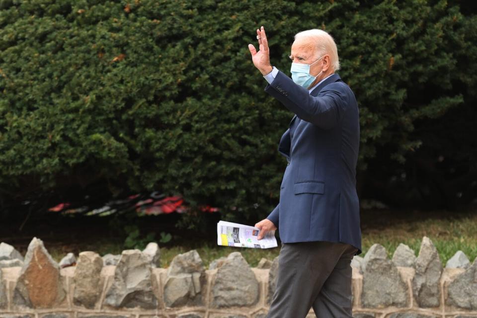 Democratic presidential nominee Joe Biden waves as he leaves St. Ann’s Parish following a service October 11, 2020 in Wilmington, Delaware. (Photo by Chip Somodevilla/Getty Images)