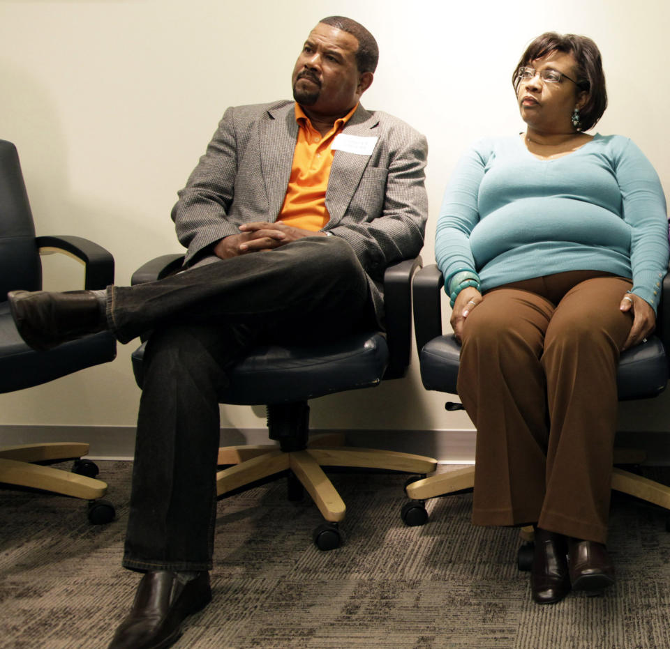 FILE - In this April 17, 2012, file photo Charles Zanders and Tereasa Jefferson, right, look on during a news conference in Des Moines, Iowa. Iowa continues to maintain an internal "do not rehire" list of fired employees who are barred from returning to state employment, even though judges have raised questions about its legality, according to a review by The Associated Press. Jefferson argued in a December trial that a white manager fired her during a probationary period in 1999, and had her added to the list. Jefferson said she unsuccessfully applied for positions repeatedly before learning in 2005 she was barred. (AP Photo/Charlie Neibergall, File)