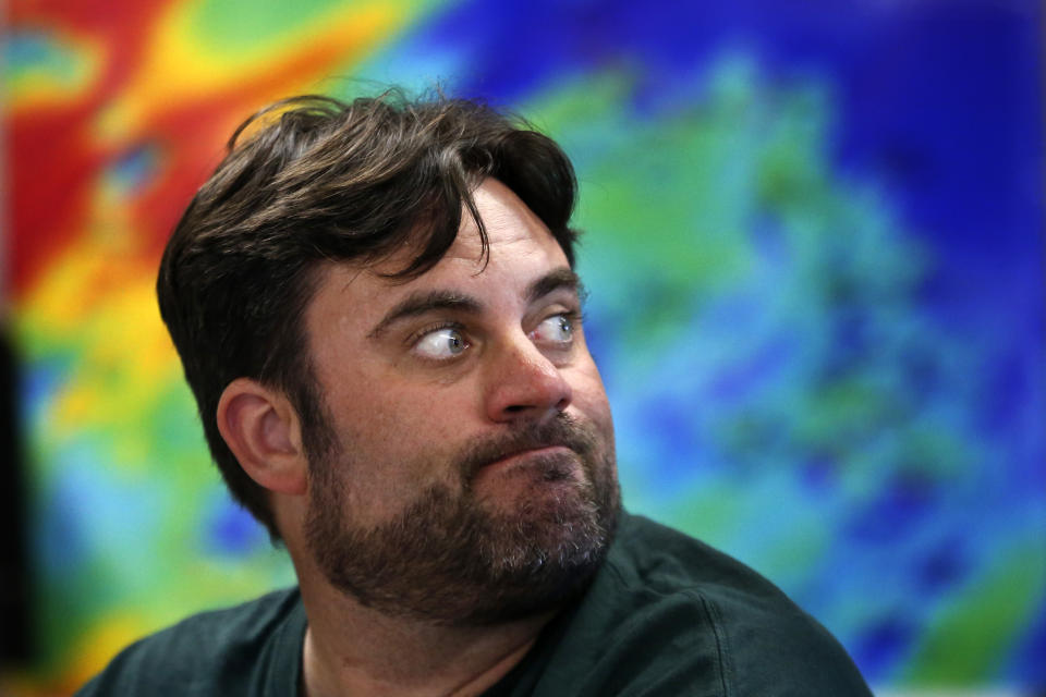 Craig Aumack, an assistant professor of biology at Georgia Southern University, looks to a video monitor while working on a research project studying the algae of Gray's Reef, aboard the NOAA Ship Nancy Foster, about 20 miles off the coast of Georgia on Wednesday, Aug. 4, 2019. Aumack notes that more tropical species are appearing on the reef as waters warm. The same is true of types of seaweed and fish like the odd-looking and colorful emerald parrotfish. It is native to the Gulf of Mexico but is now found here, most likely pushed hundreds of miles to the north by changing ocean temperatures. (AP Photo/Robert F. Bukaty)