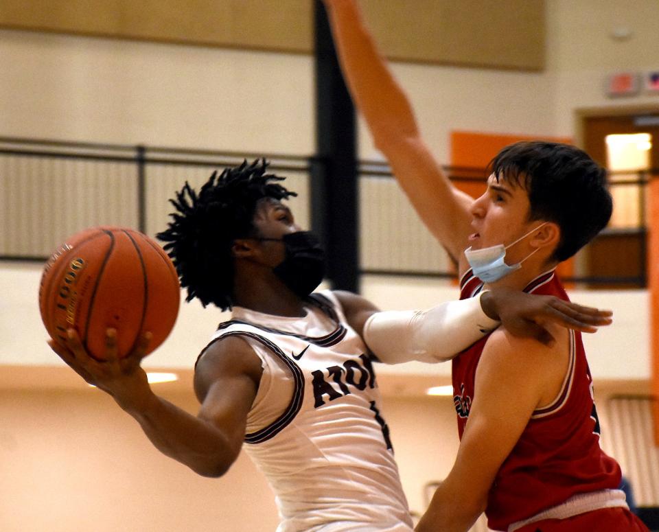 Jamir Bowles (left) attempts a driving shot for the Utica Academy of Science and draws a foul against Tamarac during the fourth quarter of Wednesday's game at the Davidson Auto Group Invitational at Rome Free Academy.