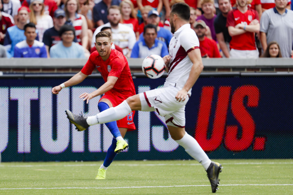 United States forward Tyler Boyd, left, attempts a cross against Venezuela defender Luis Mago, right during the first half of an international friendly soccer match, Sunday, June 9, 2019, in Cincinnati. (AP Photo/John Minchillo)