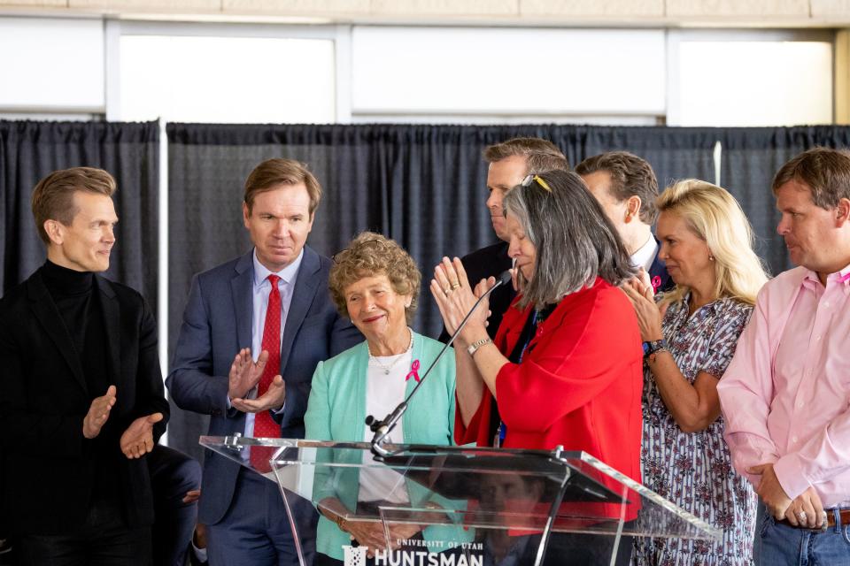 Karen Huntsman, co-founder of the Huntsman Cancer Institute, third from left, is surrounded by her children and Mary Beckerle, CEO of Huntsman Cancer Institute, front, in red, at the opening of the new Kathryn F. Kirk Center for Comprehensive Cancer Care and Women’s Cancers at Huntsman Cancer Institute in Salt Lake City on Monday, May 8, 2023. | Spenser Heaps, Deseret News