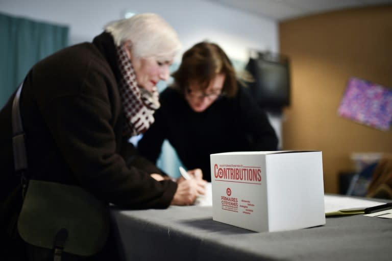 A woman signs in at a polling station during the first round of the left-wing primary for the 2017 French presidential election in Nantes on January 22, 2017