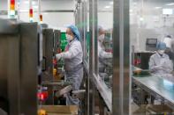 An employee works in an assembly line at a mask factory in Icheon