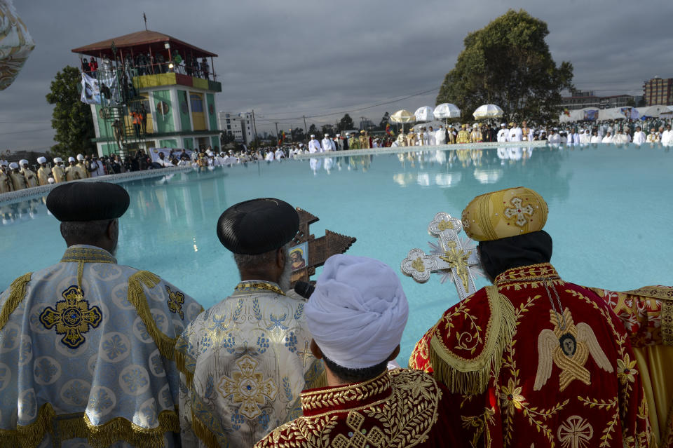 Ethiopian Orthodox Christian priests gather next to a pool of water as followers beat drums and sing religious songs to celebrate the second day of the festival of Timkat, or Epiphany, in the capital Addis Ababa, Ethiopia Wednesday, Jan. 19, 2022. The annual festival celebrates the baptism of Jesus Christ in the River Jordan. (AP Photo)