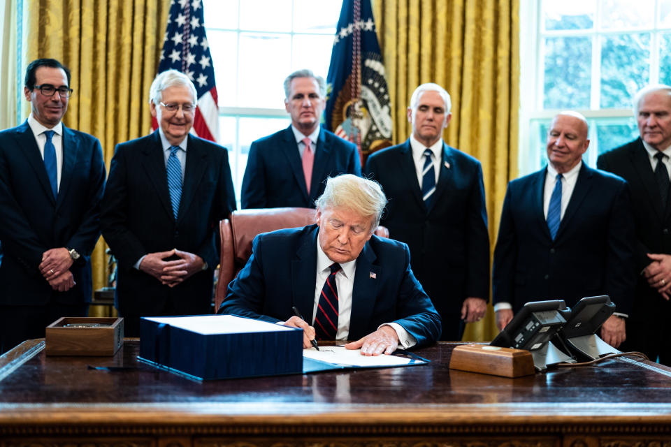 U.S. President Donald Trump signs H.R. 748, the CARES Act in the Oval Office of the White House on March 27, 2020 in Washington, D.C. (Photo: Pool via Getty Images)