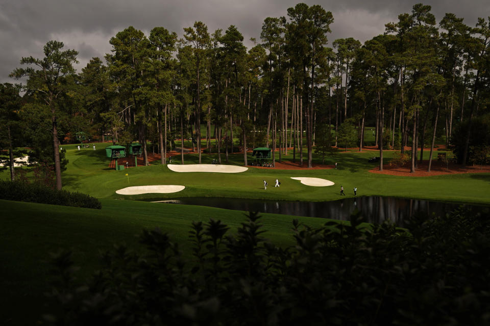 Jimmy Walker and C.T. Pan, of Taipei, walk to the 16th green with their caddies during a practice round for the Masters golf tournament Tuesday, Nov. 10, 2020, in Augusta, Ga. (AP Photo/Matt Slocum)