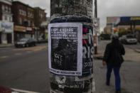 A line on a flyer posted on a lamppost in Philadelphia's west reads "Elections no! Revolution yes!" on Wednesday, Oct. 28, 2020. Protests have erupted in the neighborhood following the police shooting death of Walter Wallace, Jr. (AP Photo/Robert Bumsted)