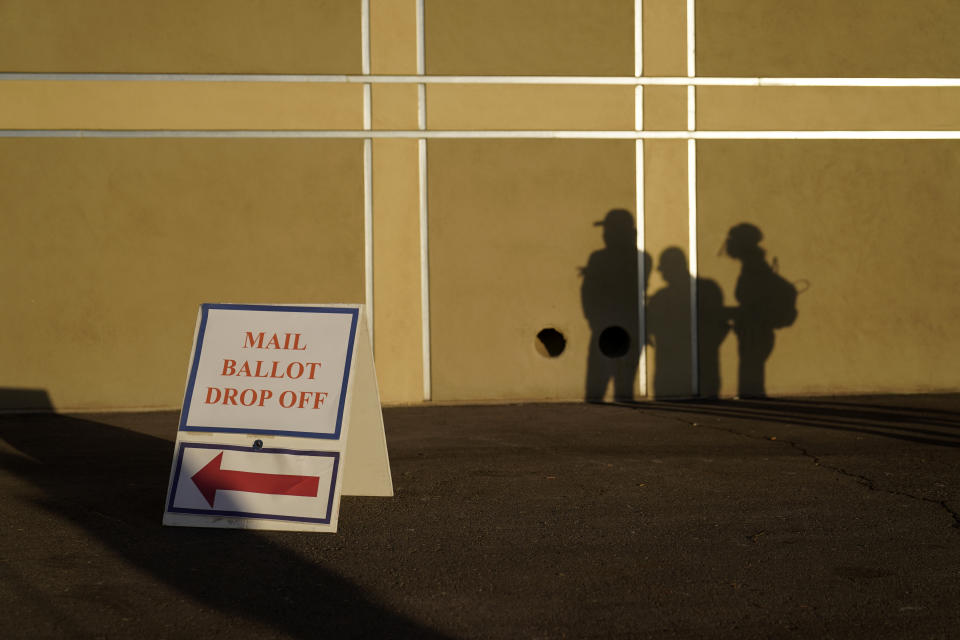 FILE - People wait outside of a polling place on Election Day on Nov. 3, 2020, in Las Vegas. Nevada voters will consider a ballot question on Nov. 8, 2022, that would enshrine in the state constitution a ban on discrimination based on race, color, creed, sex, sexual orientation, gender identity or express, age, disability, ancestry or national origin. Nevadans will also weigh in on ranked-choice voting and the state's minimum wage. (AP Photo/John Locher, File)
