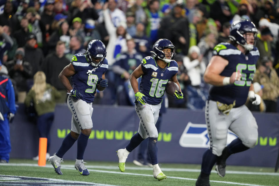 Seattle Seahawks wide receiver Tyler Lockett (16) celebrates a touchdown in the second half of an NFL football game against the Washington Commanders in Seattle, Sunday, Nov. 12, 2023. (AP Photo/Lindsey Wasson)