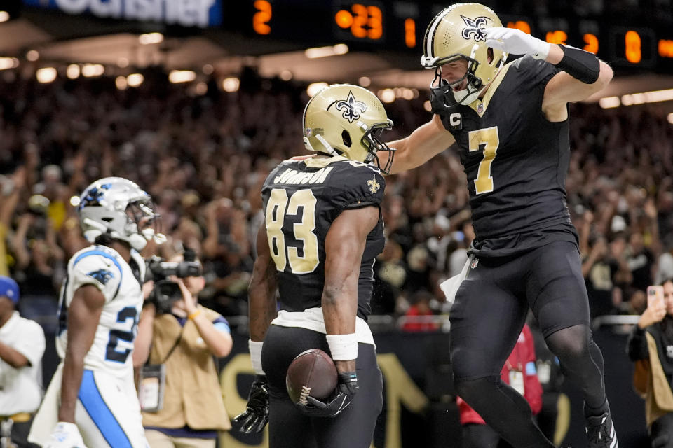 New Orleans Saints tight end Juwan Johnson (83) is congratulated by teammate Taysom Hill (7) after scoring a touchdown during the first half of an NFL football game against the Carolina Panthers, Sunday, Sept. 8, 2024, in New Orleans. (AP Photo/Gerald Herbert)