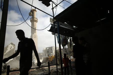 A Palestinian man walks near the remains of a mosque, which witnesses said was hit by an Israeli air strike, in Beit Hanoun in the northern Gaza Strip August 25, 2014. REUTERS/Mohammed Salem