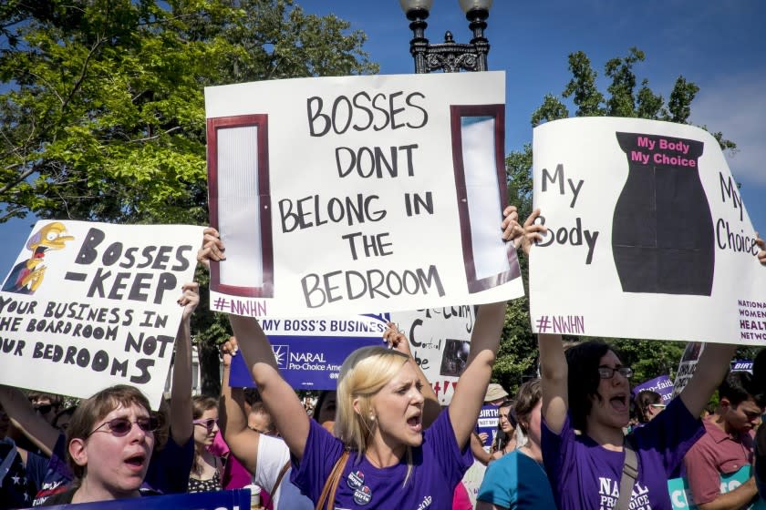 Activists who support the Affordable Care Act's employer contraceptive mandate demonstrate outside the U.S. Supreme Court in Washington.